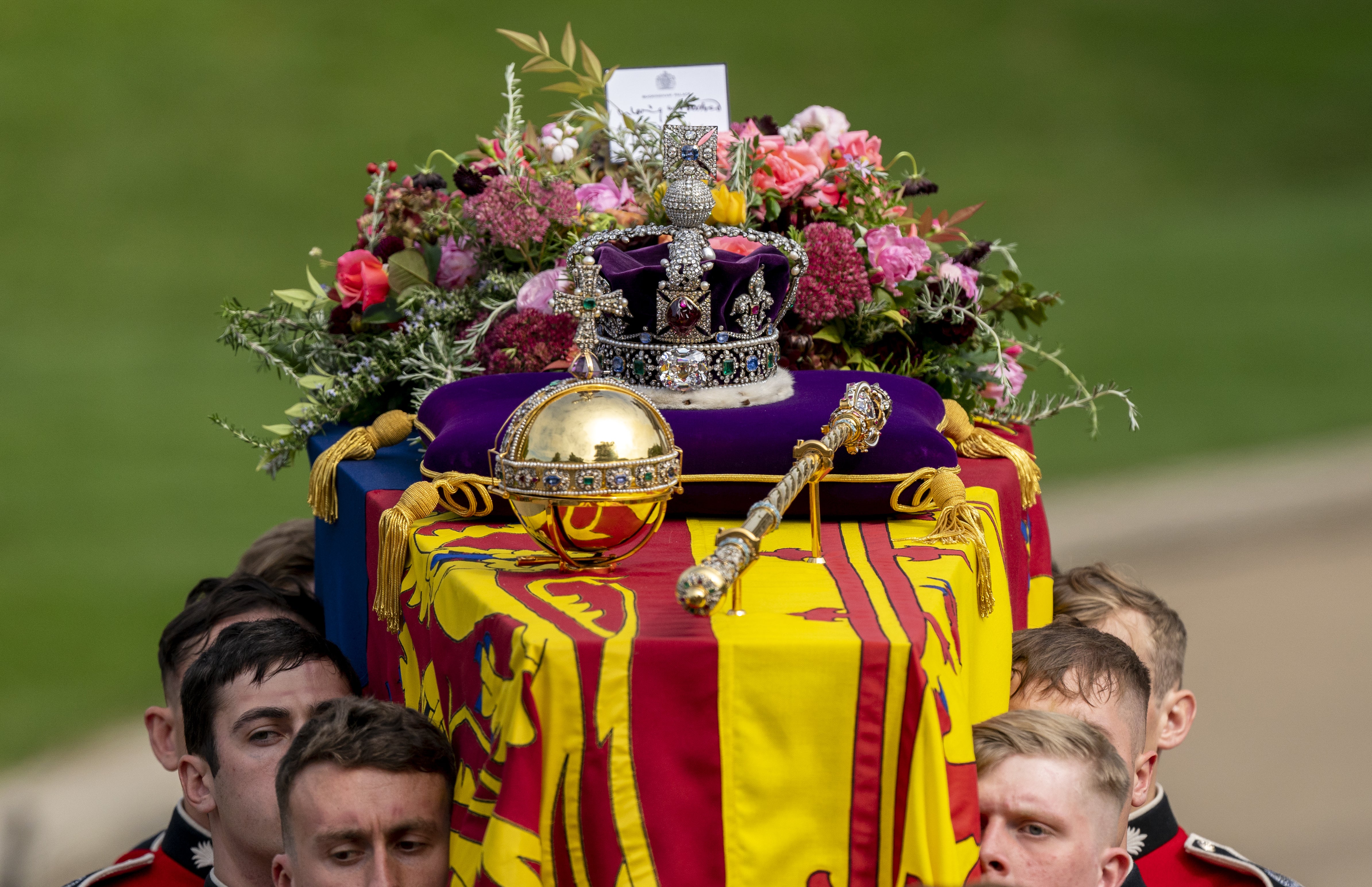 The coffin of the Queen, draped in the Royal Standard with the Imperial State Crown and the Sovereign’s orb and sceptre (PA)