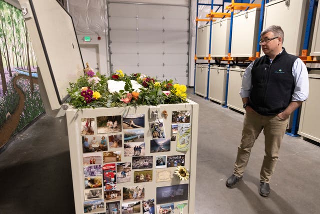 <p>Return Home CEO Micah Truman shows a demonstration "vessel" for the deceased, which has been decorated by Return Home with flowers and family photos, during a tour of the funeral home which specializes in human composting in Auburn, Washington on March 14, 2022</p>
