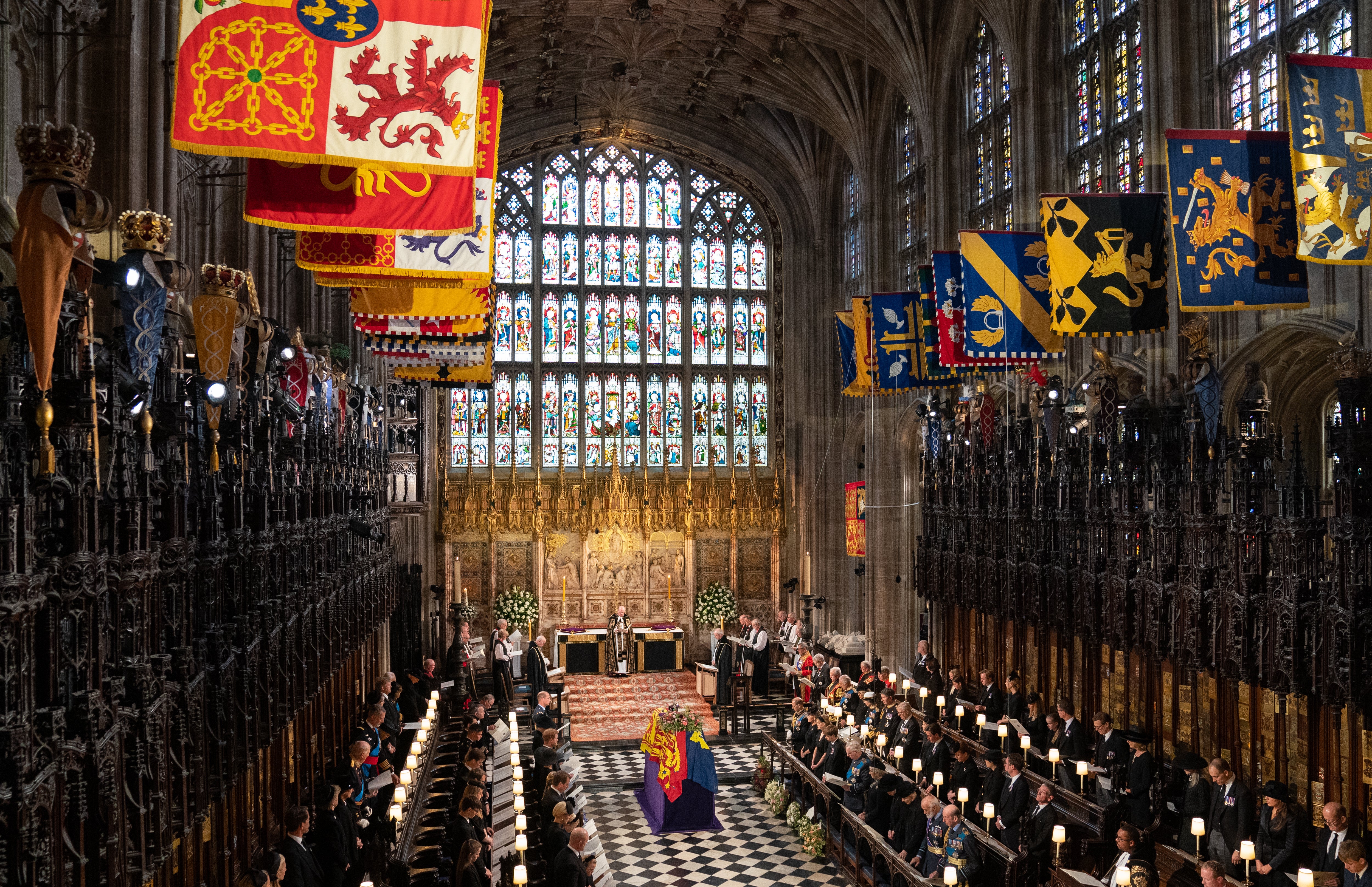 The coffin of Queen Elizabeth II, draped in the Royal Standard with the Imperial State Crown and the Sovereign’s orb and sceptre, during the Committal Service at St George’s Chapel in Windsor Castle, Berkshire. Picture date: Monday September 19, 2022.