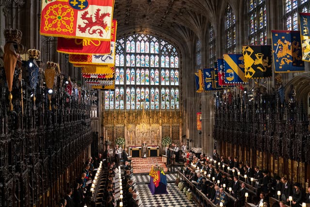 The coffin of Queen Elizabeth II, draped in the Royal Standard with the Imperial State Crown and the Sovereign’s orb and sceptre, during the Committal Service at St George’s Chapel in Windsor Castle, Berkshire. Picture date: Monday September 19, 2022.