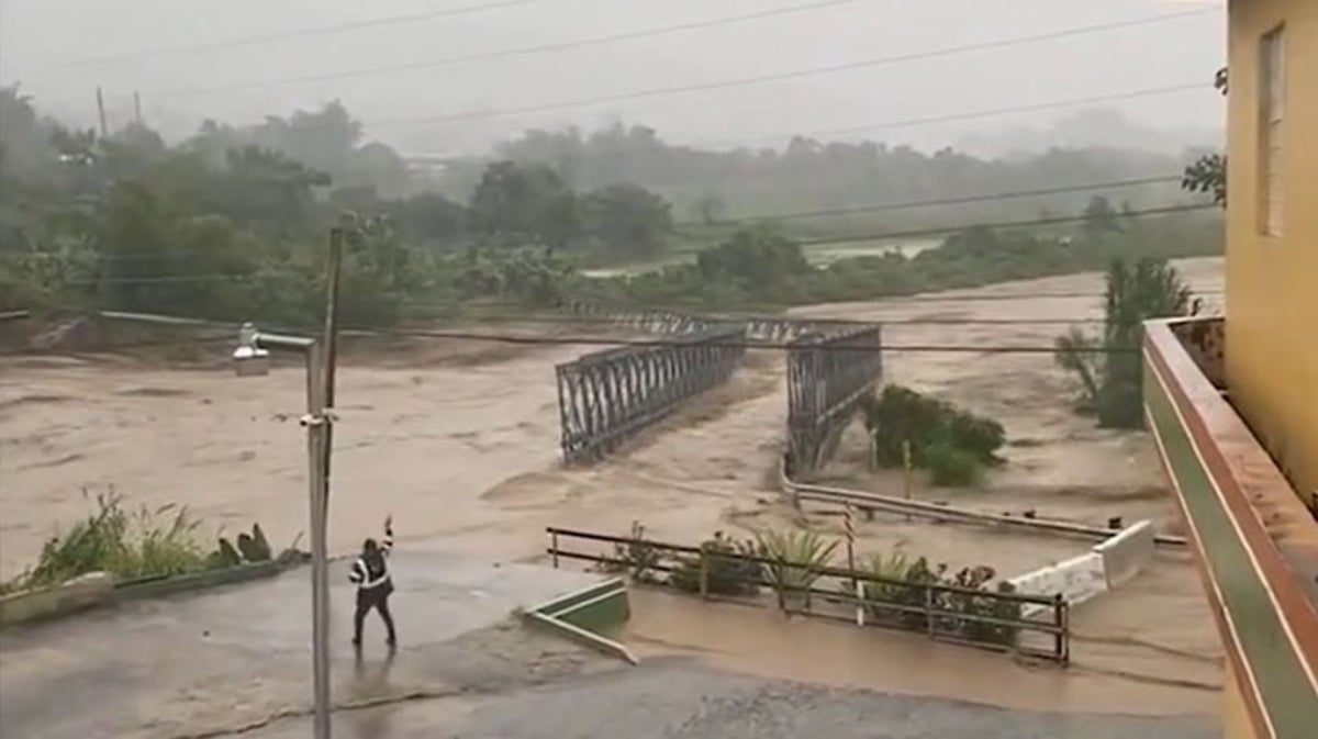 Moment bridge is swept away by floodwater as Hurricane Fiona batters Puerto Rico