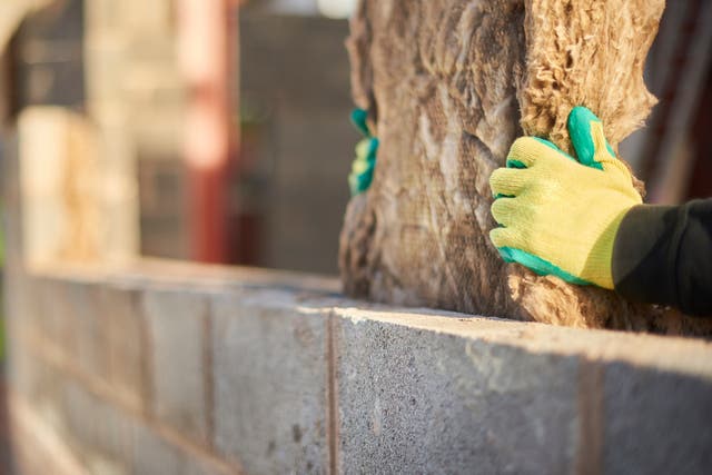 <p>Fitting cavity wall insulation. Improving the efficiency of homes would be a major boost to the economy, analysts say</p>