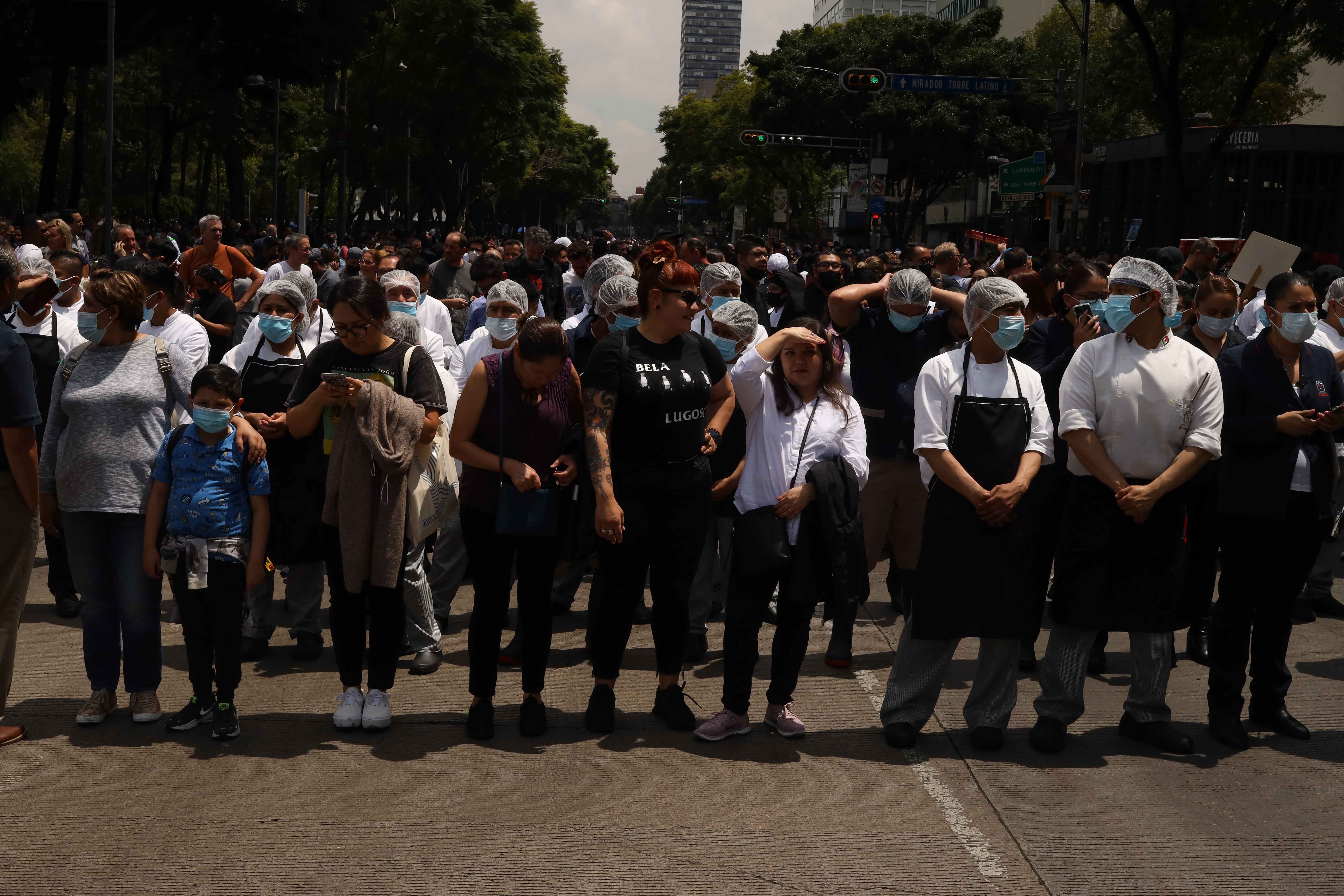 People gather outside after a 7.7 magnitude quake that struck the west coast in Michoacan State, was felt in Mexico City