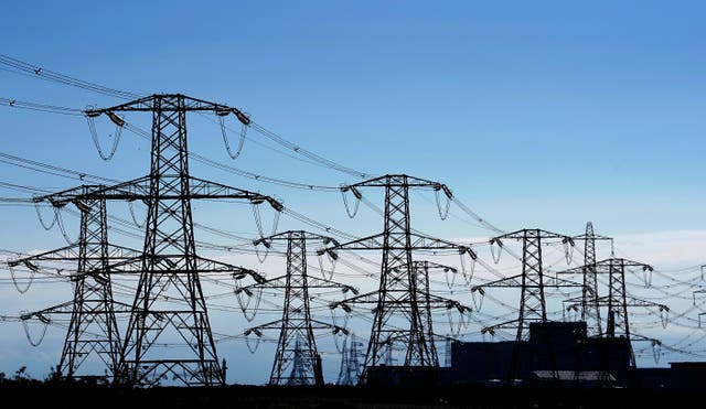 Electricity pylons run across Romney Marsh in Kent from Dungeness nuclear power station. Ofgem has confirmed an 80.06 percent rise in the energy price cap, sending the average household’s yearly bill from GBP 1,971 to GBP 3,549 from October. Picture date: Friday August 26, 2022.