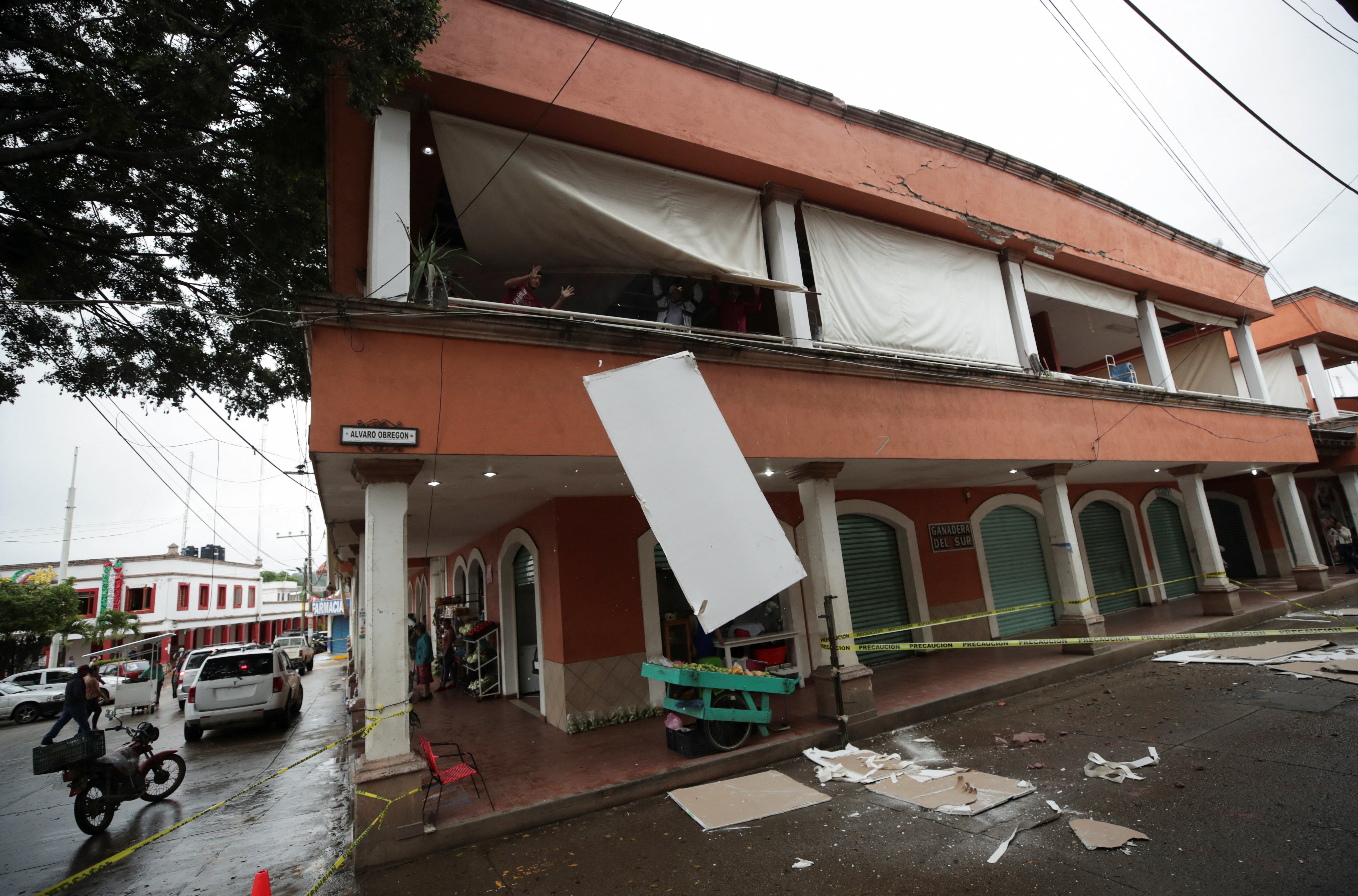 Employees remove debris at a damaged mall after an earthquake on Monday, in Coalcoman, Michoacan, Mexico September 20 2022