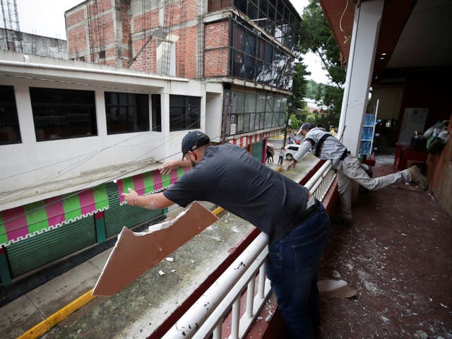 <p>Employees remove debris at a damaged mall after an earthquake on Monday, in Coalcoman, Michoacan, Mexico September 20 2022</p>