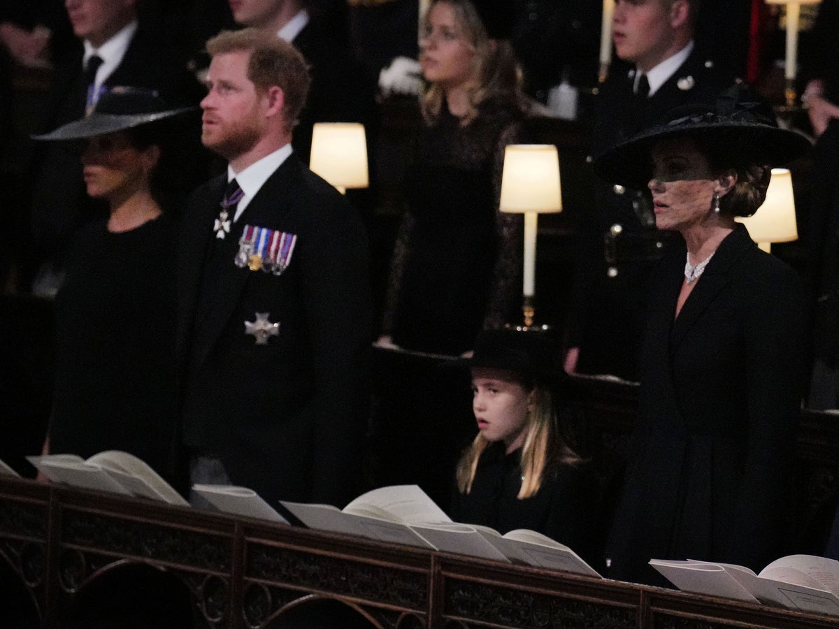 Prince Harry sweetly smiles at Princess Charlotte during Queen Elizabeth II’s funeral