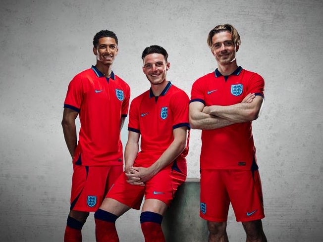 Jude Bellingham, Declan Rice and Jack Grealish pose in England’s official away kit for the 2022 World Cup