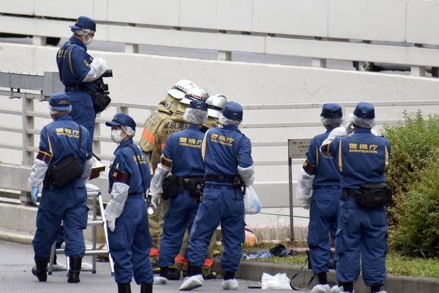 <p>Police officers investigate at the site where a man who was protesting a state funeral for former Japanese Prime Minister Shinzo Abe set himself on fire</p>