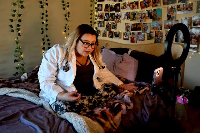 <p>Nicole Spencer, who suffers from Postural Orthostatic Tachycardia Syndrome, prepares to record a video for her Instagram account</p>
