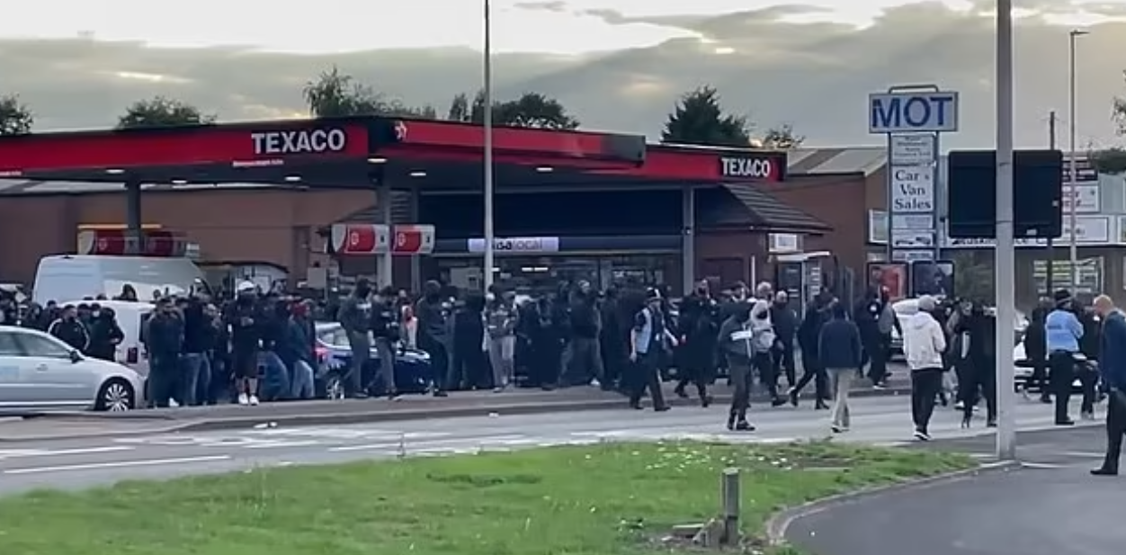 <p>A group of men gathered outside a Hindu temple in Birmingham</p>