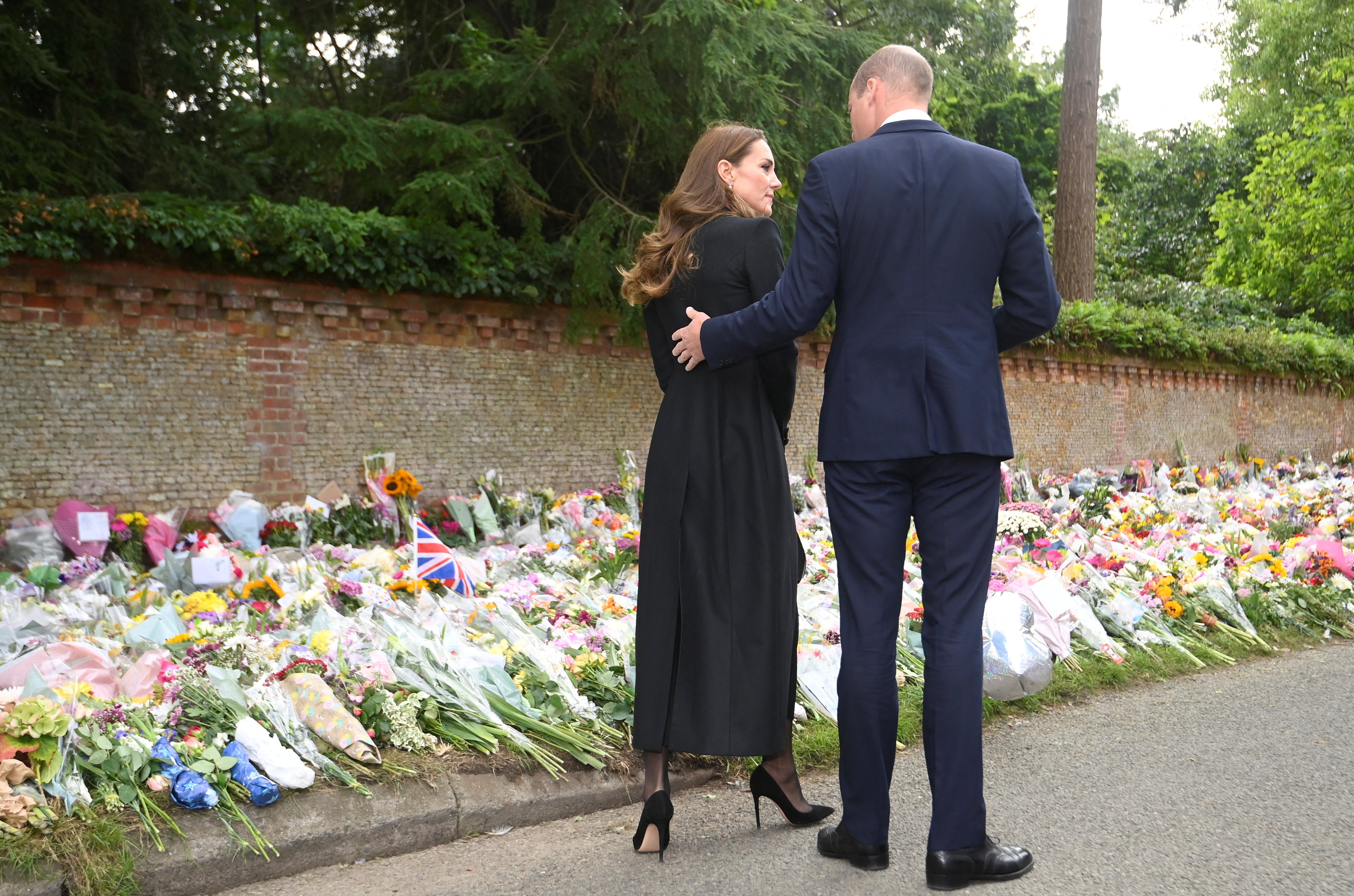 The Prince and Princess of Wales viewing floral tributes left by members of the public at the gates of Sandringham House in Norfolk (Toby Mellville/PA)