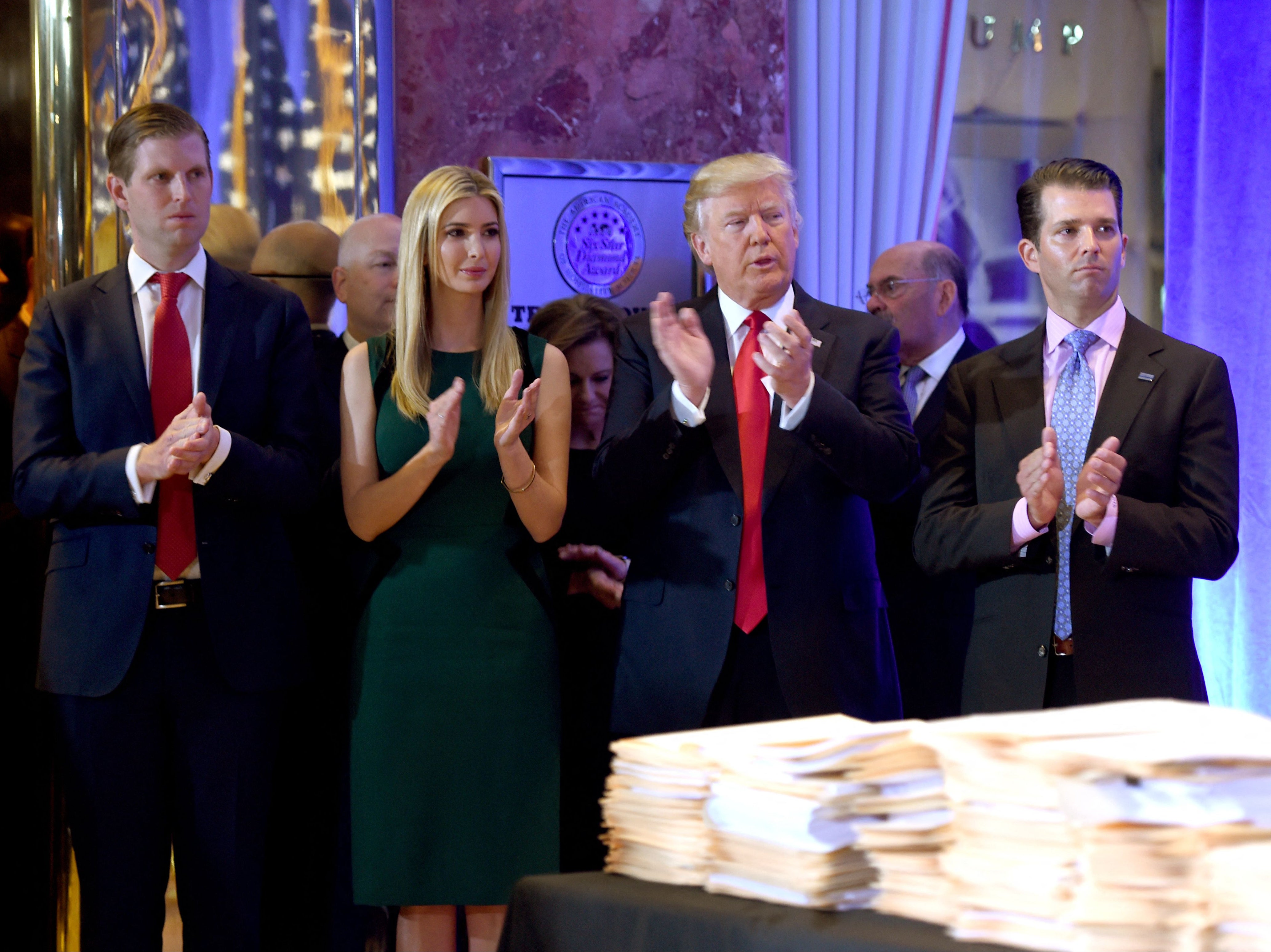 Donald Trump along with his children Eric (L), Ivanka and Donald Jr., arrive for a press conference January 11, 2017 at Trump Tower in New York