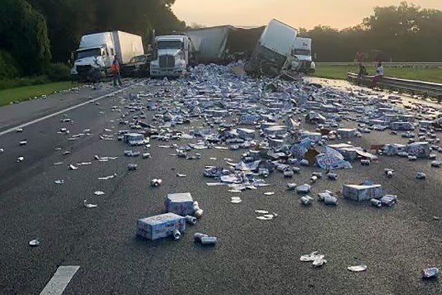 <p>Cases of Coors Light beer are strewn across a highway after two semitrailers collided</p>