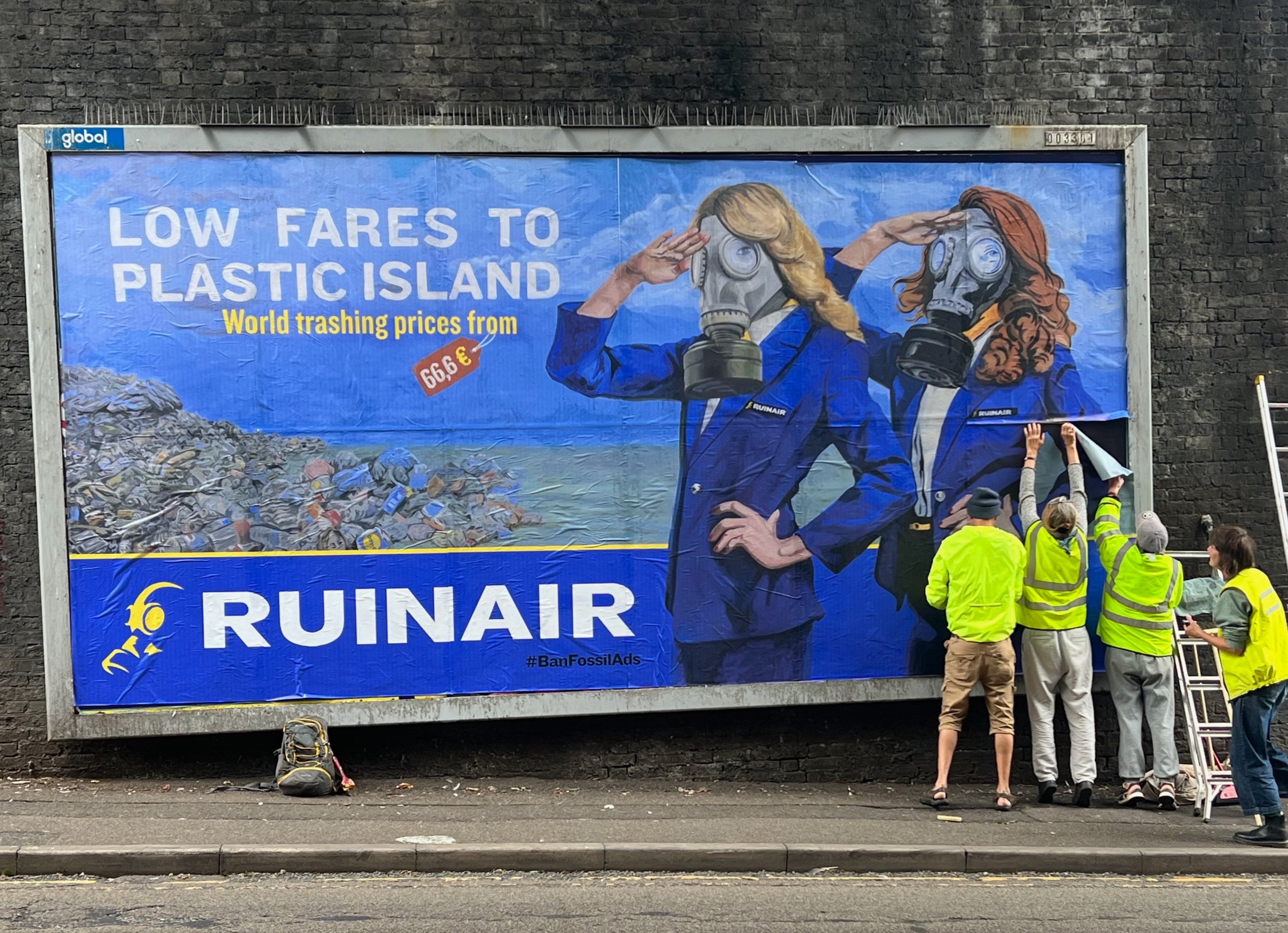 Climate protesters paste subversive advert on a billboard in Brighton