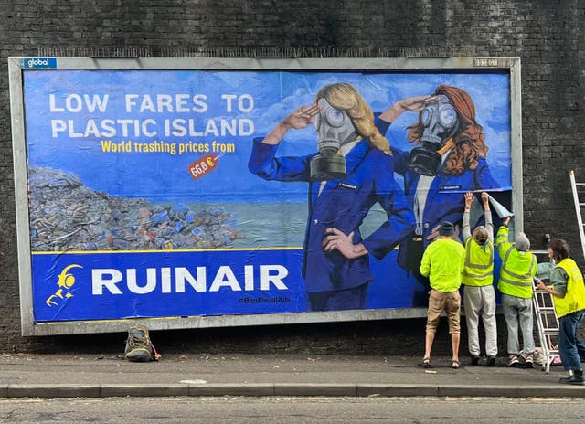 <p>Climate protesters paste subversive advert on a billboard in Brighton</p>