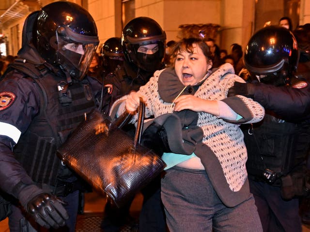 <p>Police officers detain a woman in Moscow during widespread protests against Vladimir Putin’s order for partial mobilisation</p>