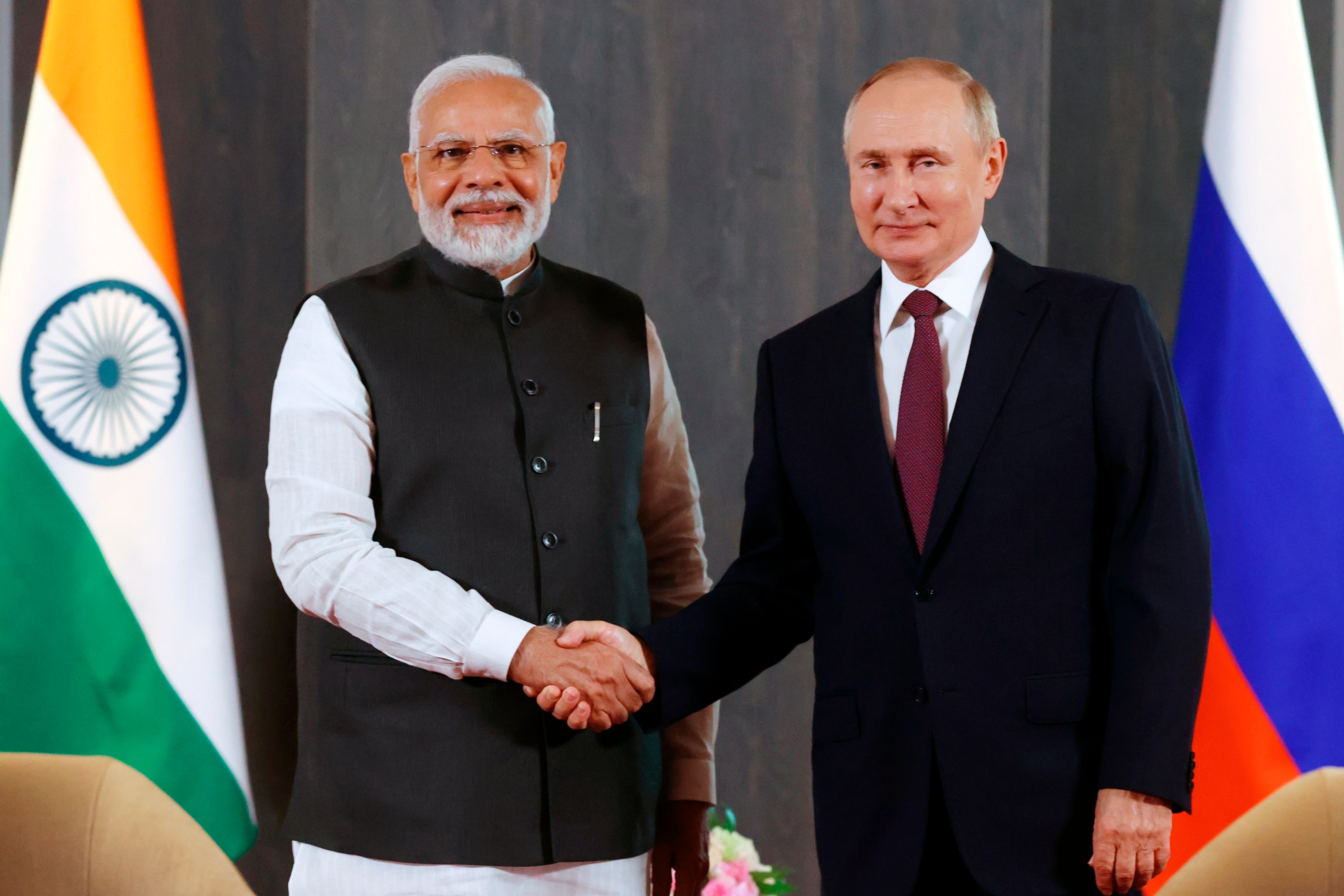 Russian President Vladimir Putin, right, and Indian Prime Minister Narendra Modi pose for a photo shaking hands prior to their talks on the sidelines of the Shanghai Cooperation Organisation
