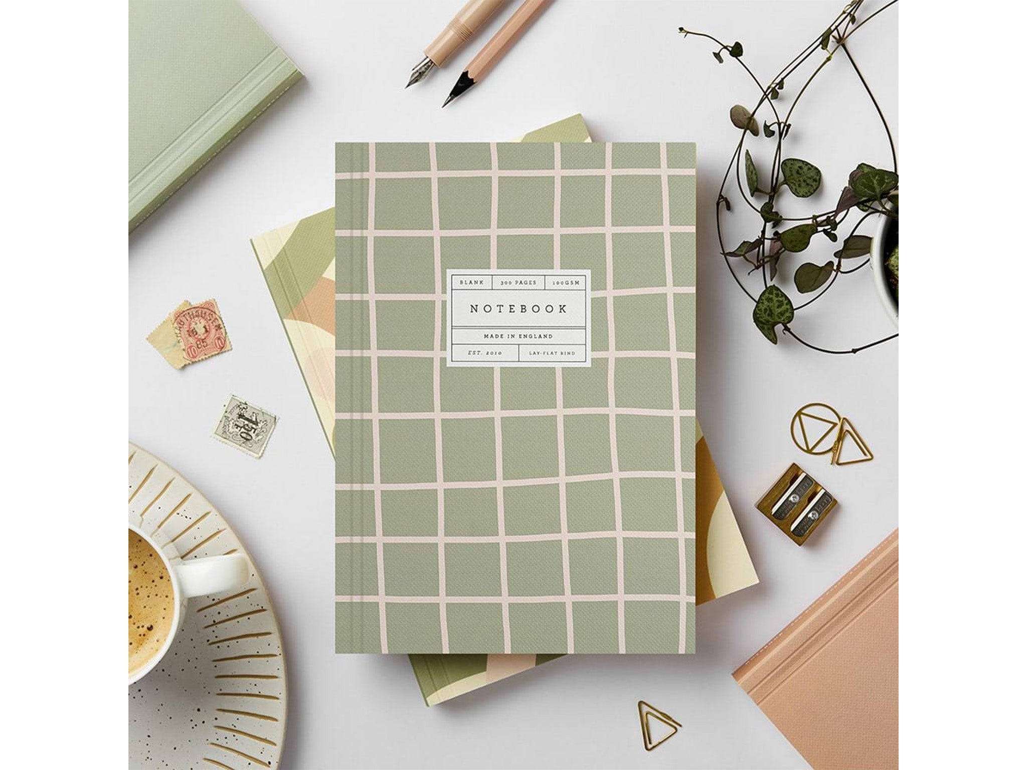 Katie Leamon flatlay notebook in green and pink grid