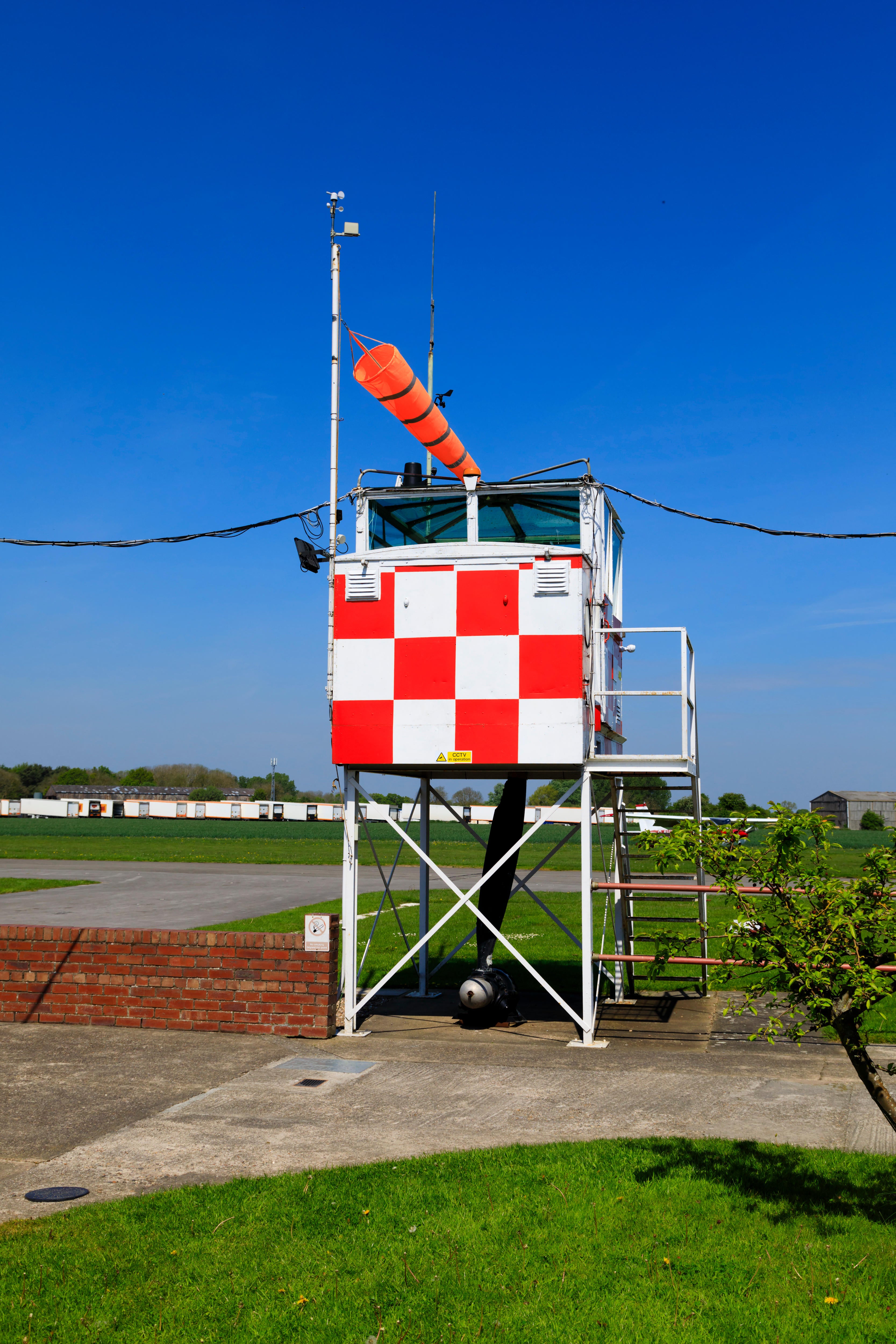 T8YMAK Control tower and windsock at the former RAF Breighton airfield in the East Riding of Yorkshire. Home to the Lincoln Aero Club and the Real Aeroplane