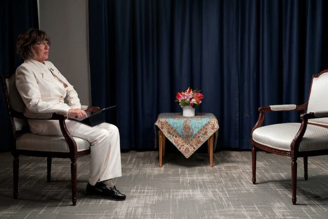 <p>Christiane Amanpour sits next to an empty chair after Iran’s president Ebrahim Raisi backed out of an interview over her refusal to wear a headscarf </p>