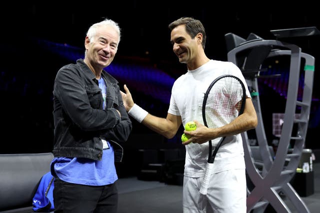 <p>Roger Federer talks to John McEnroe during a practice session ahead of the Laver Cup at The O2 Arena on 20 September 2022 in London</p>