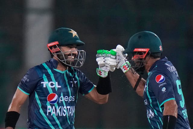 Pakistan’s Mohammad Rizwan, left, and captain Babar Azam celebrate scoring runs (Anjum Naveed/AP)