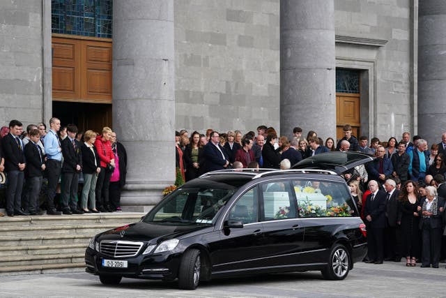Mourners gather behind the hearse carrying the coffin bearing the remains of Mikey and Thelma Dennany in Longford, following their funeral Mass (Brian Lawless/PA)