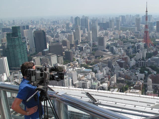 <p>Distant dream: Cameraman films the Tokyo skyline</p>