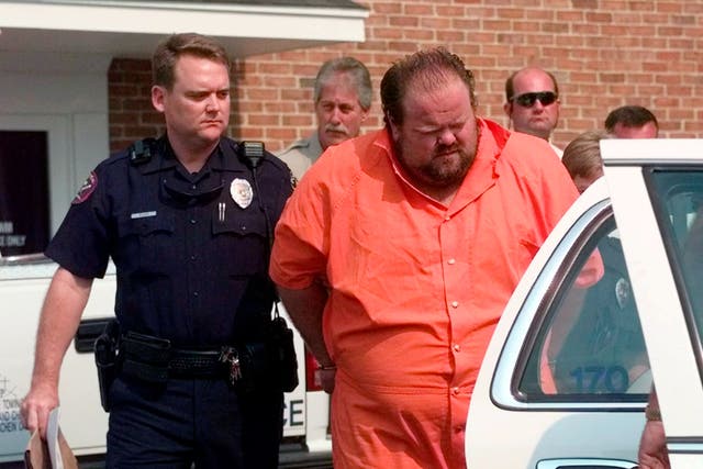 <p>Officials escort murder suspect Alan Eugene Miller away from the Pelham City Jail in Ala., on Aug. 5, 1999</p>