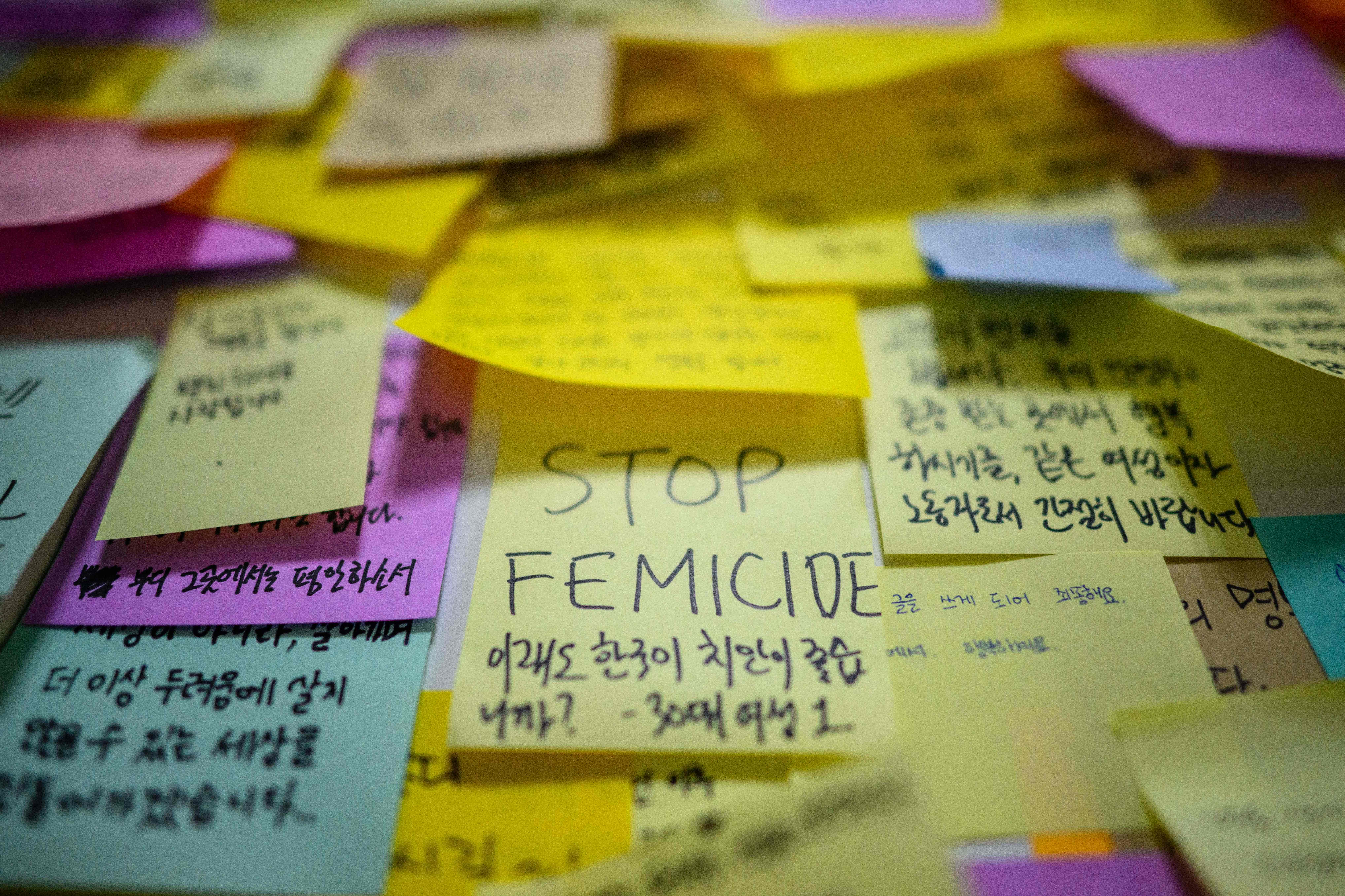 Handwritten notes are displayed near the entrance to a female lavatory at Sindang Station in Seoul on September 19, 2022