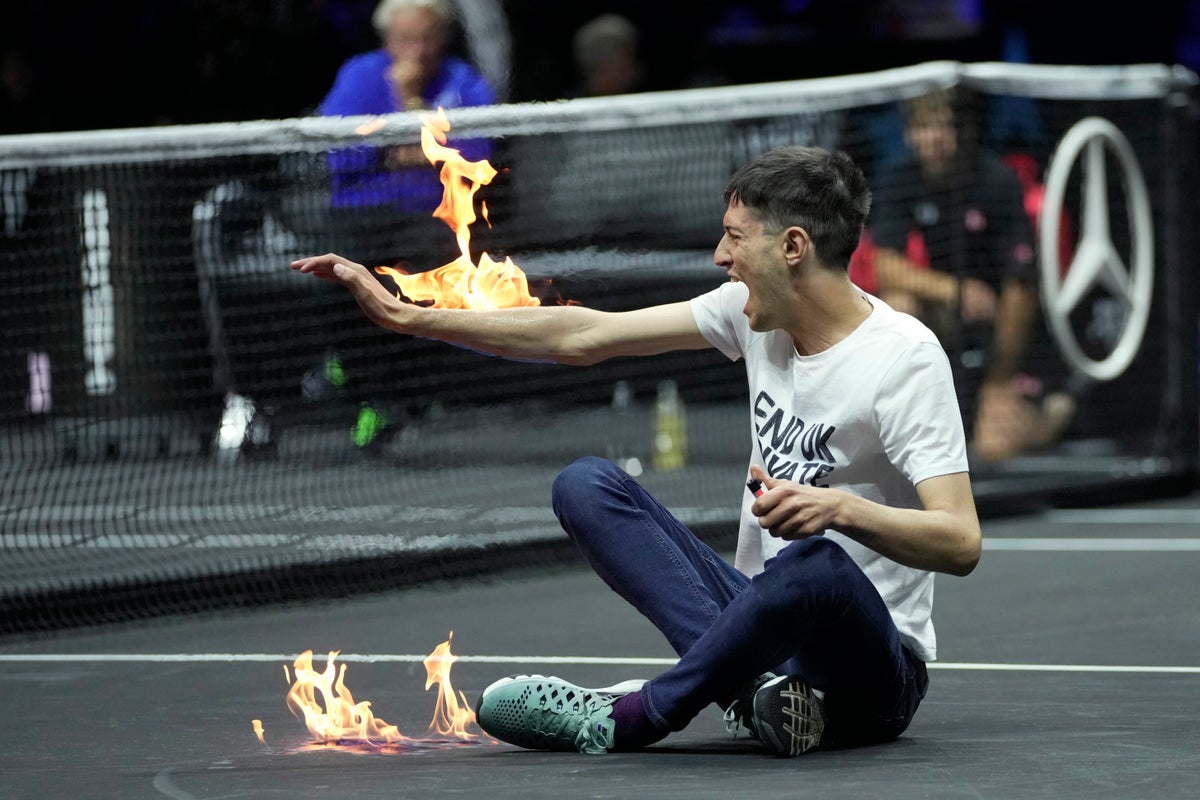 Climate change protester sets arm on fire during Laver Cup match