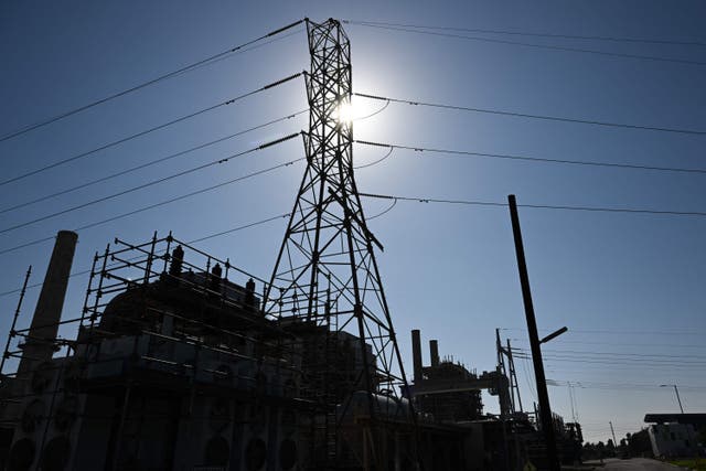 <p>The sun shines above a natural gas-fired electric power generating unit from the 1950s in Long Beach, California. The state is taking ambitious strides to reduce its fossil fuel reliance this decade</p>