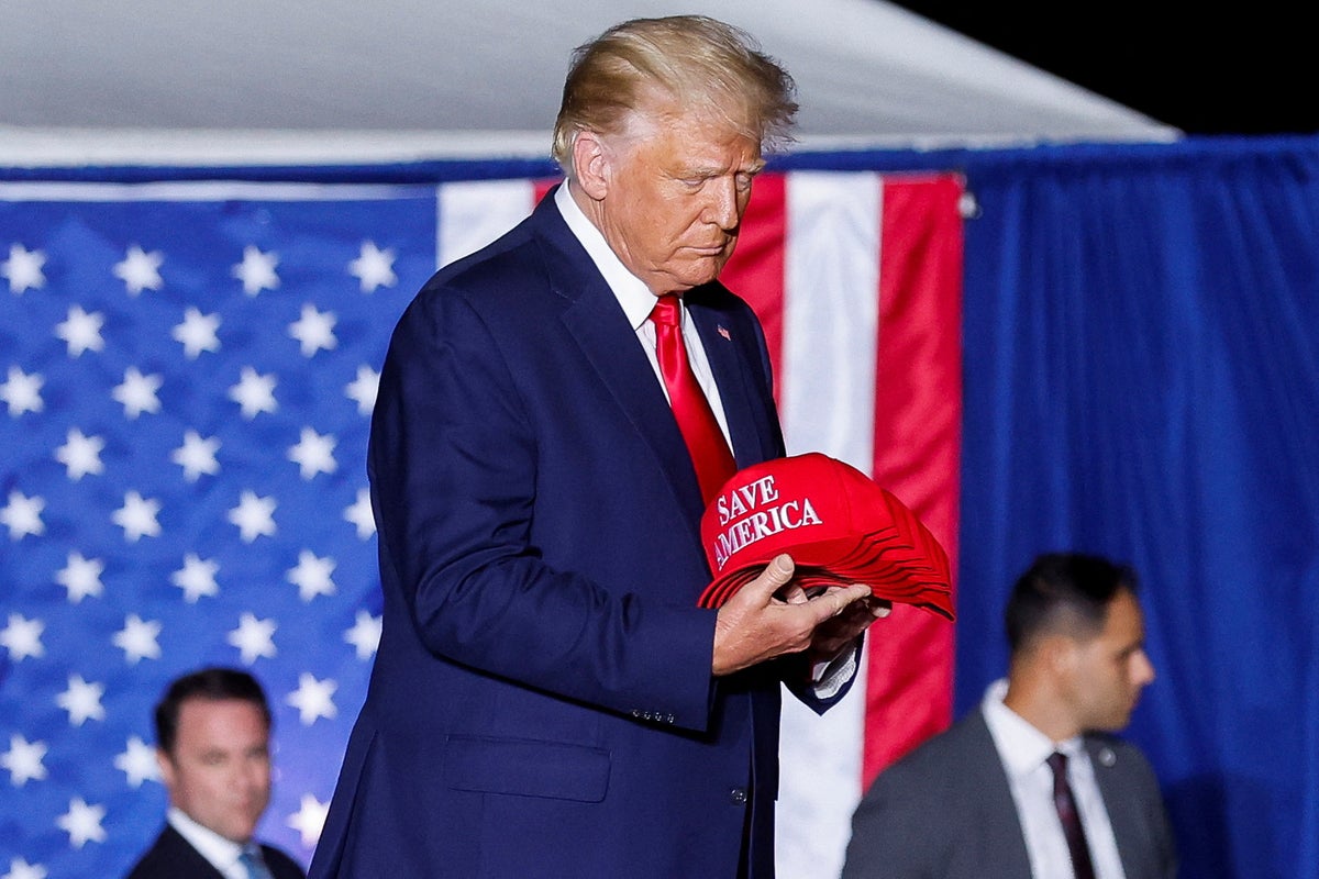 Trump news – live: QAnon posts on Truth Social under fire as followers salute ex-president at latest rally