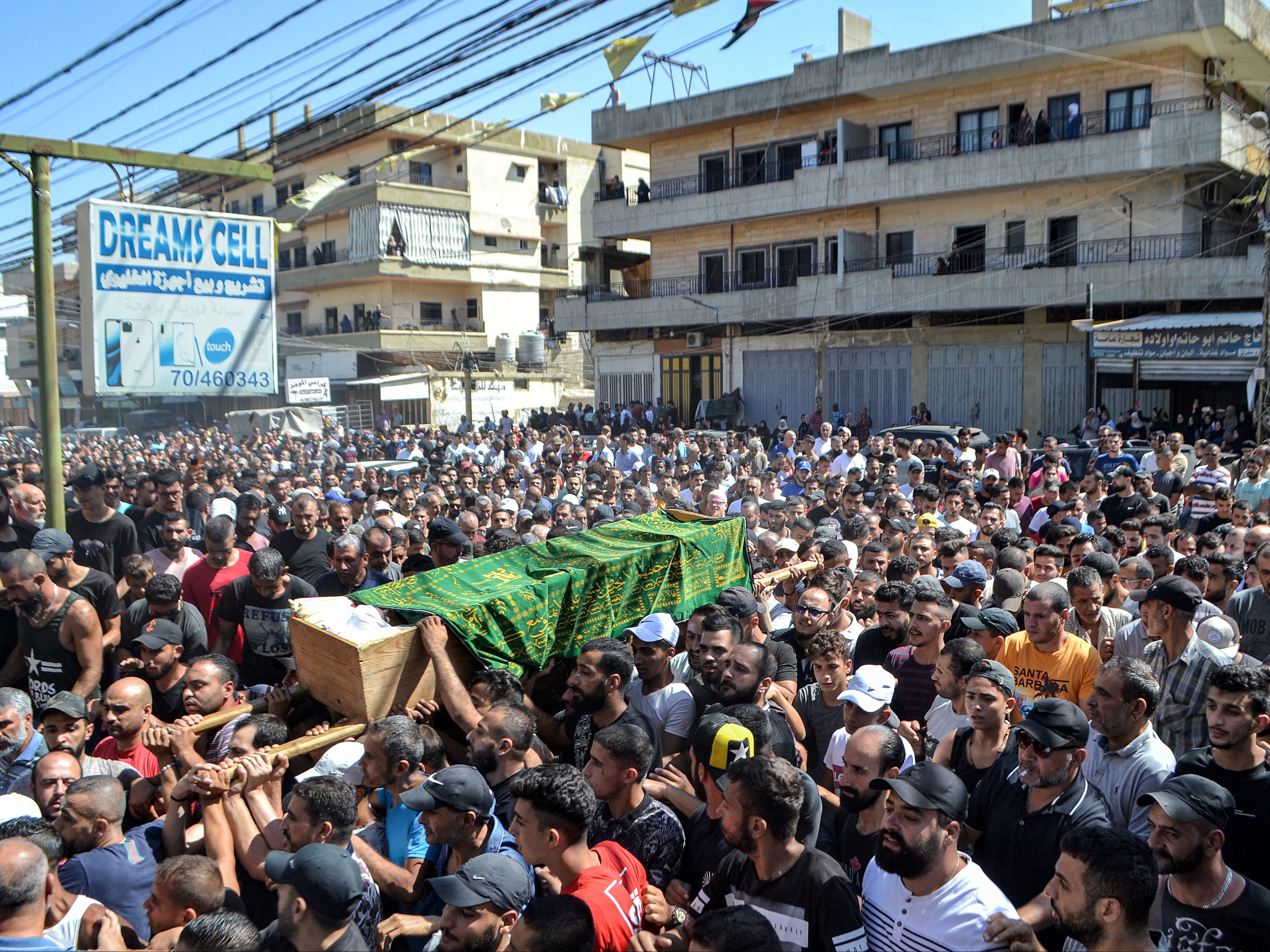 Mourners march with the body of one of the victims who drowned in the shipwreck off the Syrian coast
