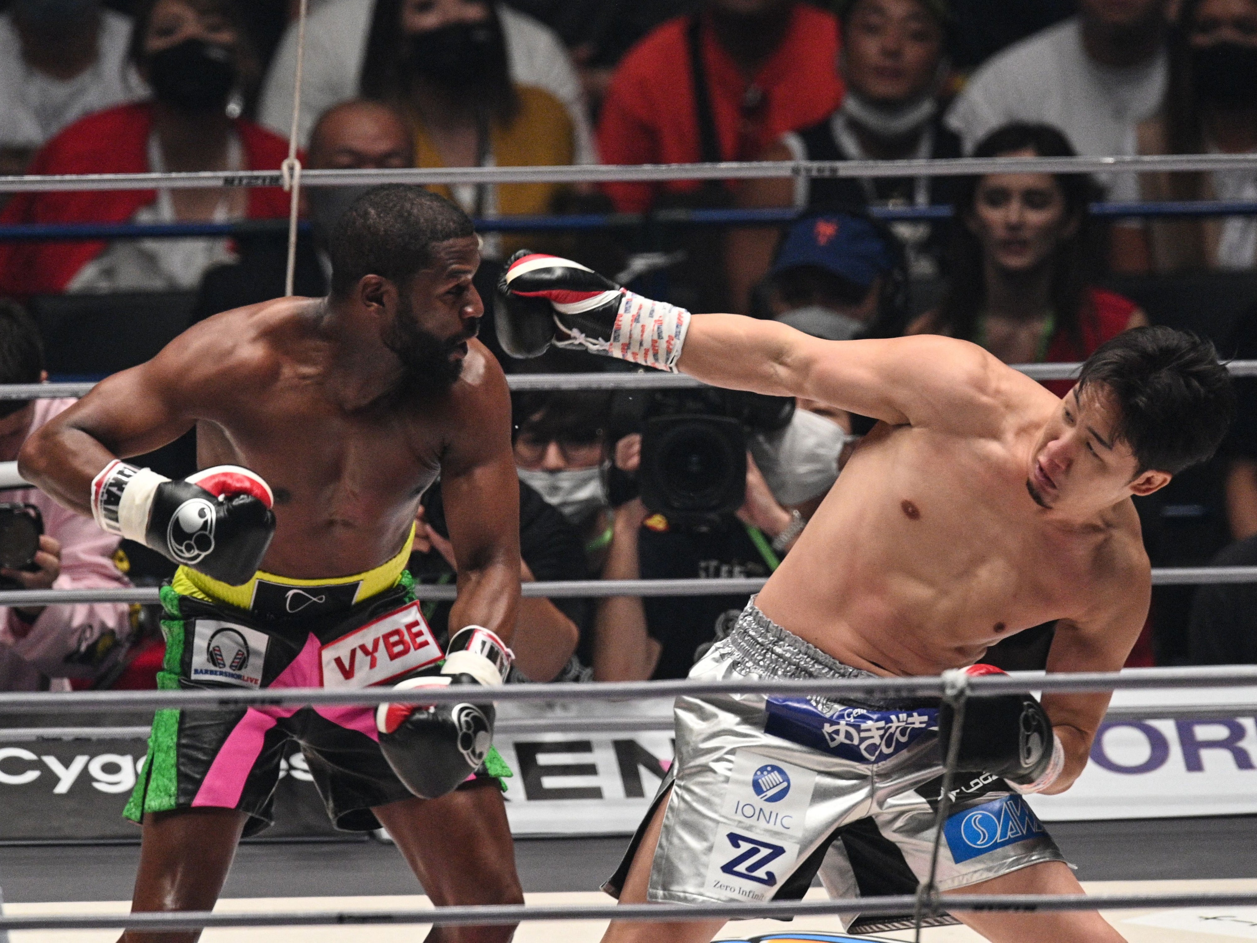 Floyd Mayweather (left) stopped Mikuru Asakura in the second of three scheduled rounds