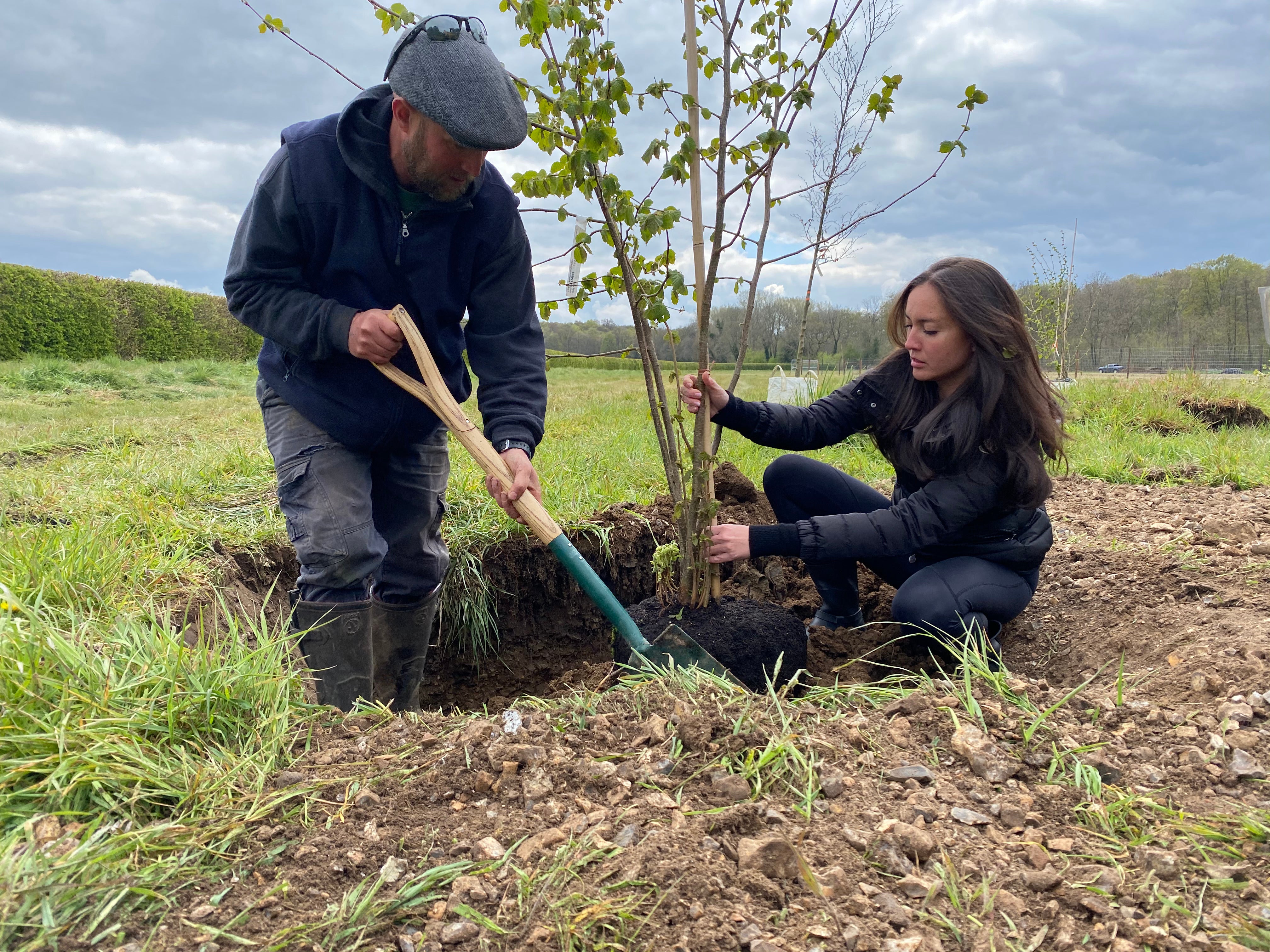 Mandy Lieu (right) planting the first trees for the first forest garden (Ewhurst Park/PA)
