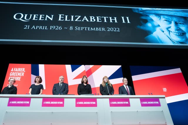 Labour party leader Sir Keir Starmer (right) leads tributes to the Queen as the national anthem is sung during the Labour Party conference in Liverpool (Stefan Rousseau/PA)