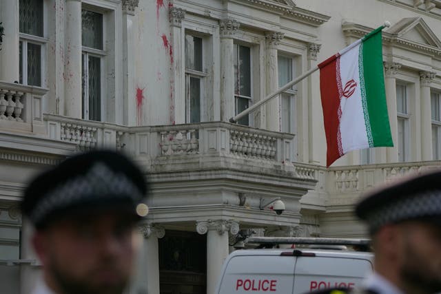 <p>Police stand guard outside the Iranian Embassy after a small group of protesters threw paint at the building</p>