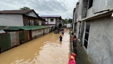 Philippines residents wade through floodwater in wake of Typhoon Noru