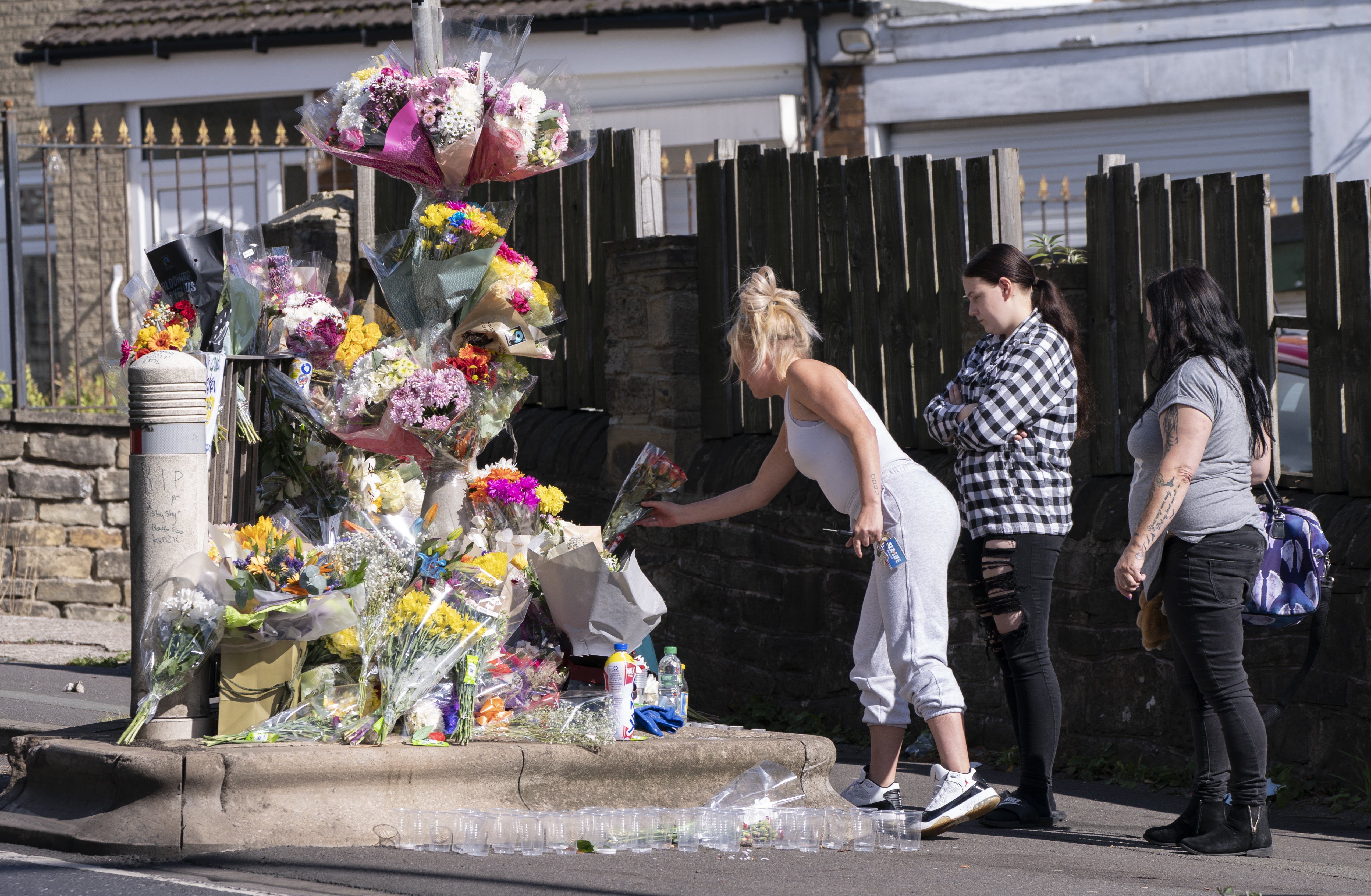 Floral tributes have been left at the scene of the attack, with candles and bottles of Yazoo milkshake placed near the spot where Khayri was stabbed