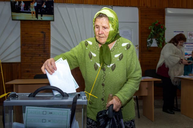 <p>An elderly woman casts her ballot during a referendum in Luhansk, Luhansk People's Republic controlled by Russia-backed separatists, eastern Ukraine</p>