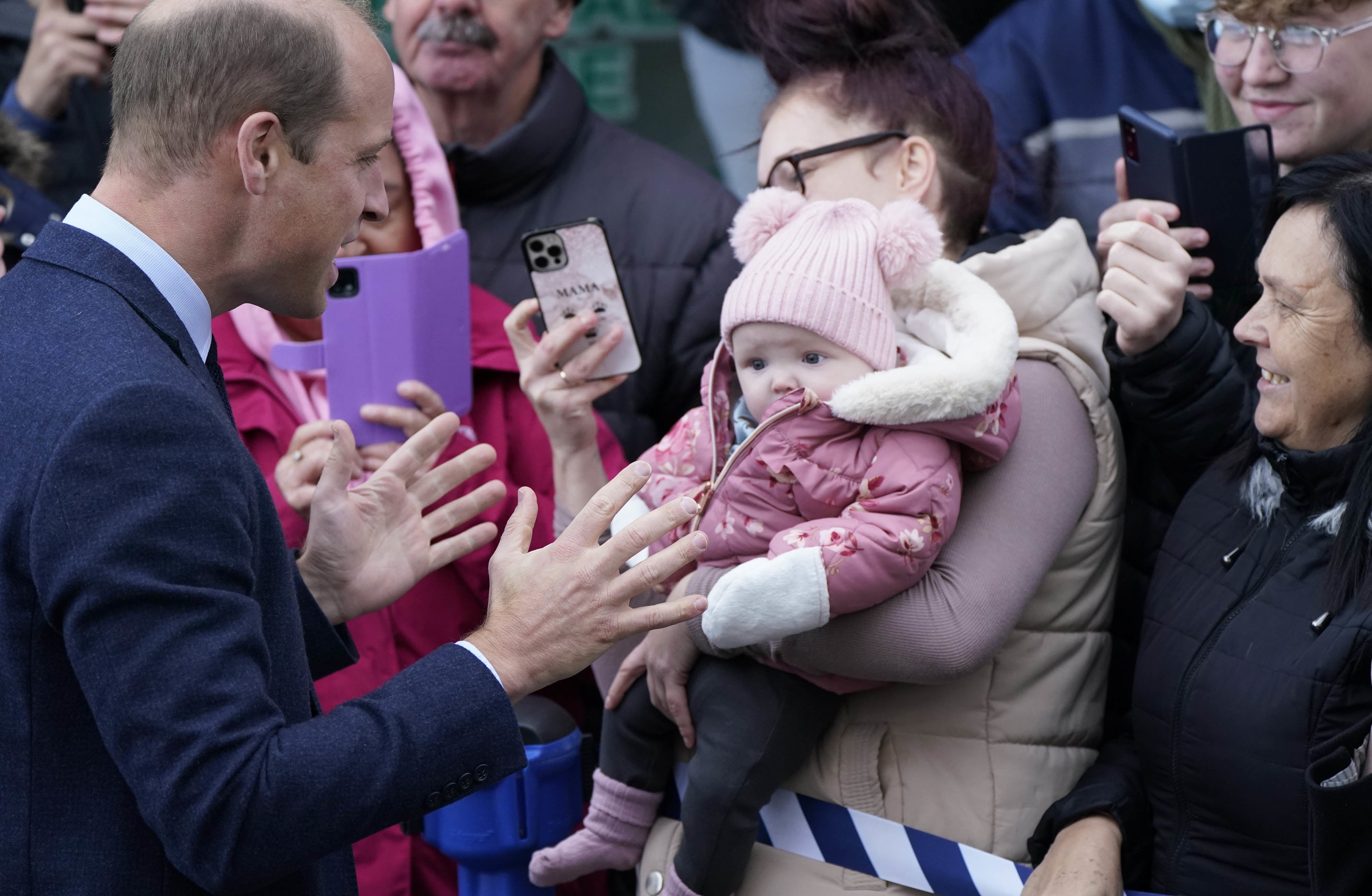 The Prince of Wales meets members of the public during a visit to Holyhead Marine Cafe and Bar in Holyhead, Wales (Danny Lawson/PA)