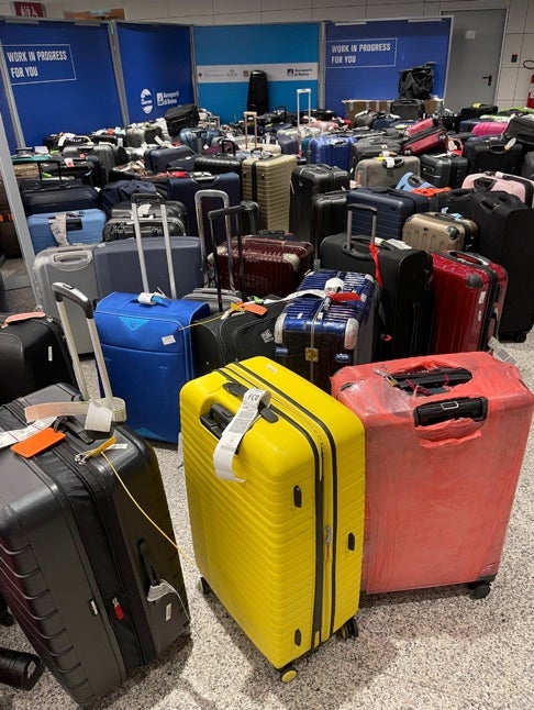 Lisa Khan’s luggage among a pile of lost bags at Florence Airport