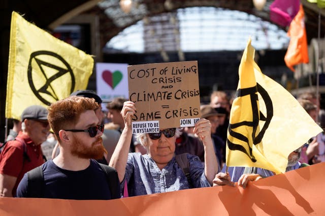 <p>Demonstrators take part in a protest march from Victoria station to Parliament Square, in London, on July 23, 2022 to demand action over the cost of living crisis and the climate change crisis.</p>