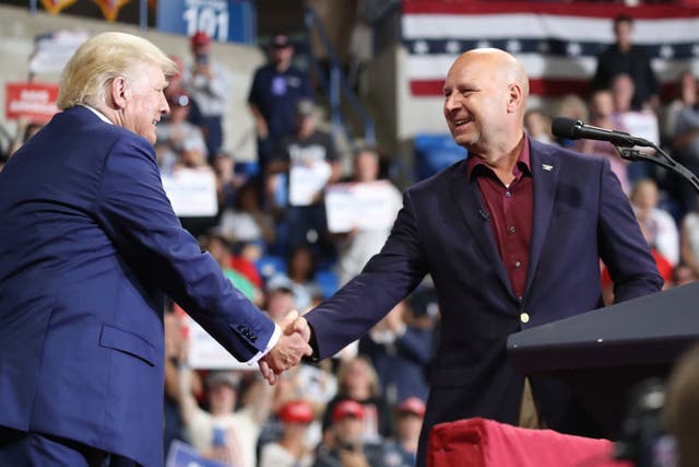 <p>Doug Mastriano shakes Donald Trump’s hand at a rally</p>