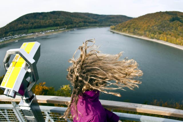 <p>For representation purpose: A girl has her hair disheveled as she stands on a viewing platform over the Edersee lake near Hemfurth, western Germany</p>