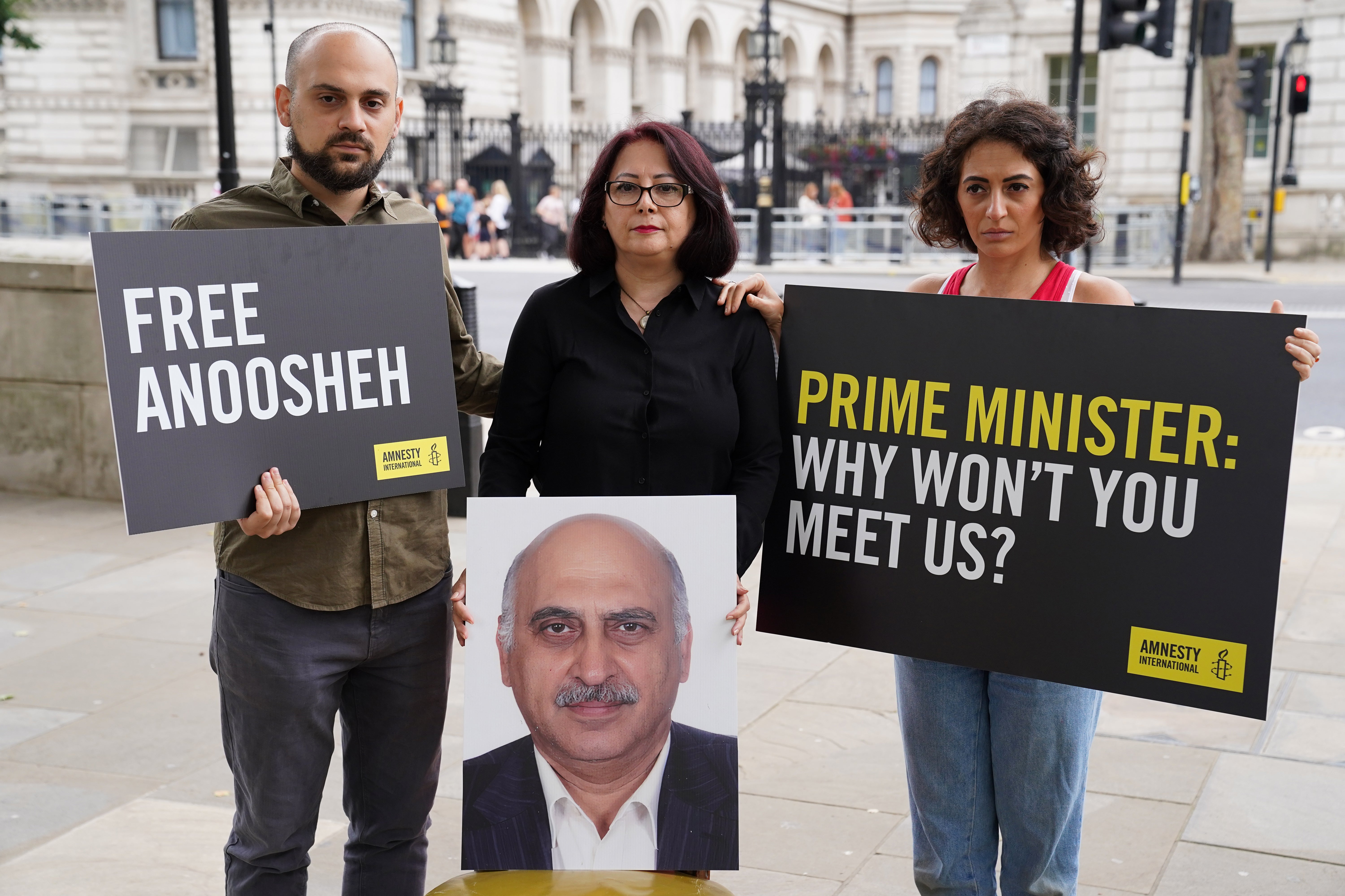 (Left to right) Aryan Ashoori, Sherry Izadi and Elika Ashoori, the son, wife and daughter of Anoosheh Ashoori, protesting the imprisonment of Mr Ashoori in London (Kirsty O’Connor/PA)
