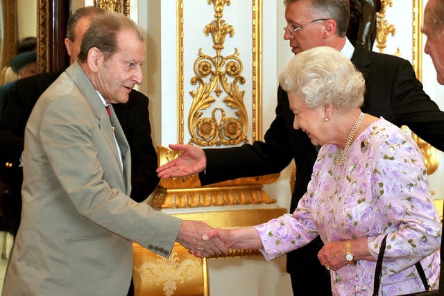 Queen Elizabeth II shakes hands with artist, Lucian Freud before lunch for members of the Order of Merit at Buckingham Palace in London (John Stillwell/PA)