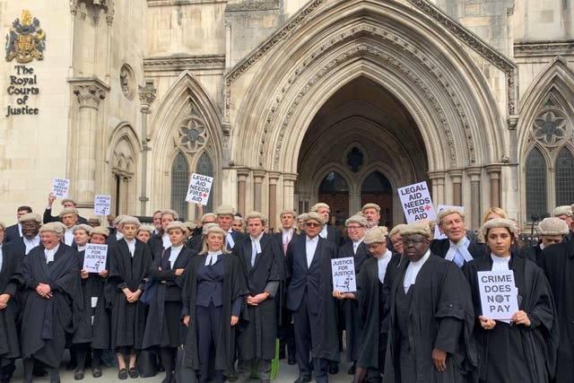 Criminal barristers from the Criminal Bar Association demonstrate outside the Royal Courts of Justice in London, as part of their ongoing pay row with the Government (Tom Pilgrim/PA)